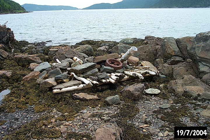 Remnant ballast from a fishing stage at Biche Arm East, including the flywheel from an early 20th-century make and break engine.
